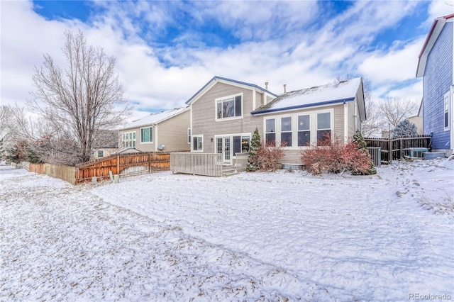 view of snow covered back of property