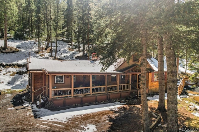 27802 Shadow Mountain Dr, Conifer, CO 80433 - snow covered house with a porch