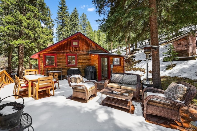 27802 Shadow Mountain Dr, Conifer, CO 80433 - snow covered patio featuring an outdoor living space, outdoor dining space, and a patio area