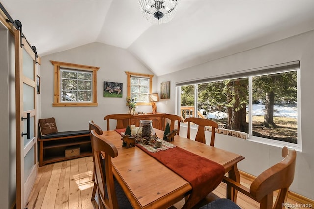 27802 Shadow Mountain Dr, Conifer, CO 80433 - dining space with light wood-style flooring, lofted ceiling, and a barn door