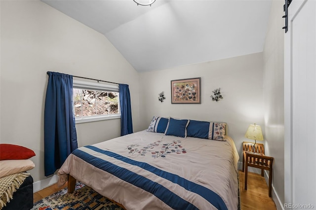 27802 Shadow Mountain Dr, Conifer, CO 80433 - bedroom featuring lofted ceiling, wood finished floors, and baseboards