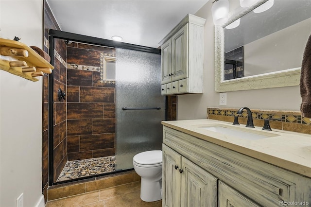 27802 Shadow Mountain Dr, Conifer, CO 80433 - full bath with a shower stall, toilet, vanity, and tile patterned flooring