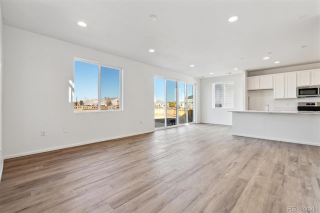 unfurnished living room with light hardwood / wood-style floors