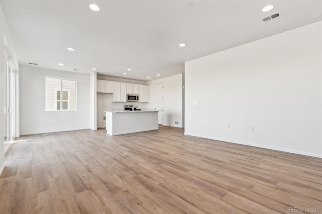 unfurnished living room featuring light wood-type flooring