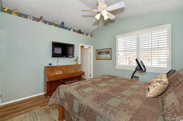 bedroom with ceiling fan, lofted ceiling, and hardwood / wood-style floors