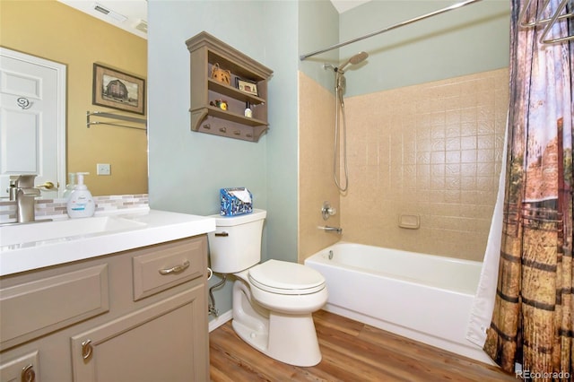 full bathroom featuring hardwood / wood-style flooring, vanity, shower / tub combo with curtain, and toilet