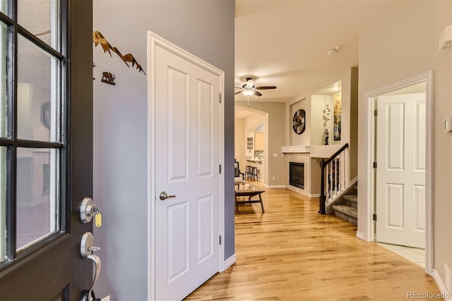 3120 Redhaven Way, Highlands Ranch, CO 80126 - corridor featuring light wood-style floors, baseboards, stairway, and arched walkways