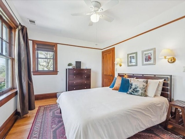 bedroom with baseboards, light wood-style flooring, and ceiling fan