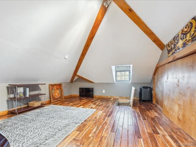 additional living space with wood finished floors and baseboards