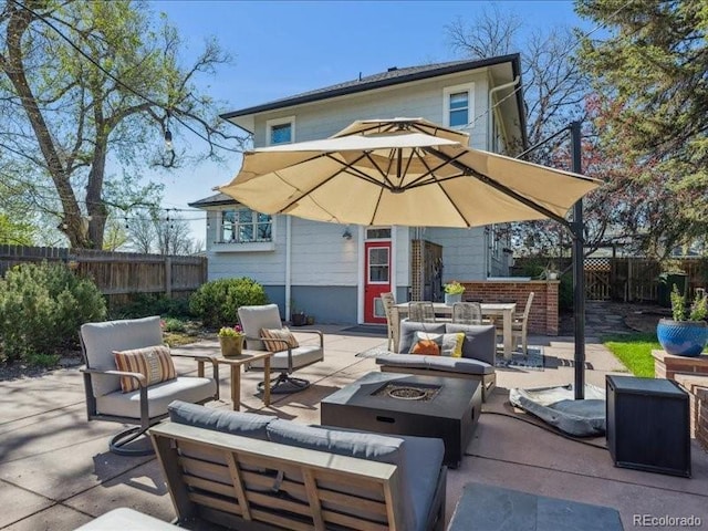 view of patio / terrace featuring an outdoor living space with a fire pit and a fenced backyard
