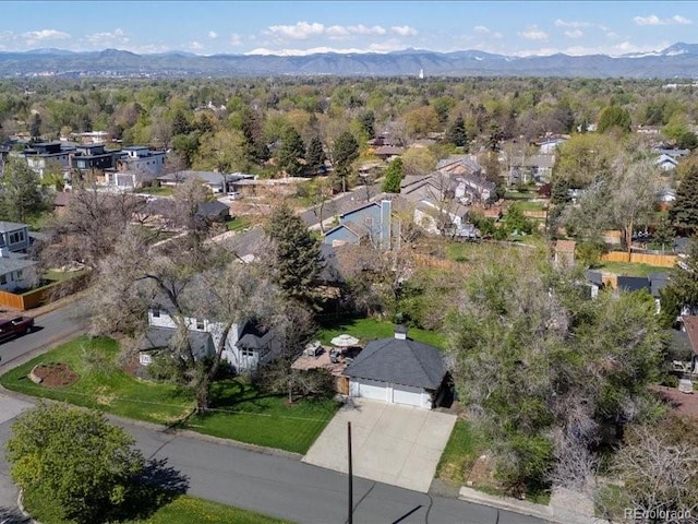aerial view of property's location with a mountain backdrop and nearby suburban area