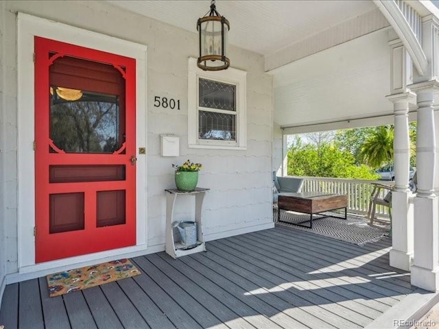 view of exterior entry featuring a porch