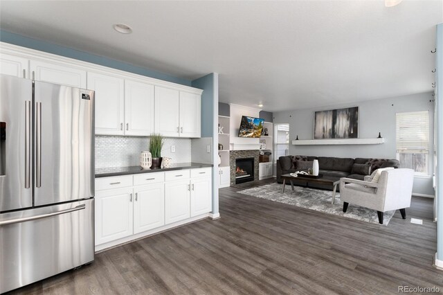 kitchen with white cabinetry, stainless steel fridge, tasteful backsplash, and dark wood-type flooring