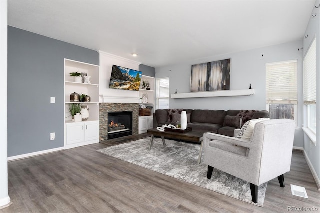 living room with a fireplace and dark hardwood / wood-style floors