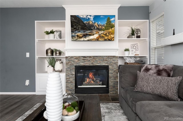 living room with dark hardwood / wood-style flooring and a fireplace