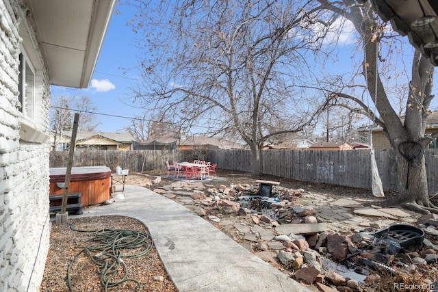 view of yard with a hot tub and a patio area