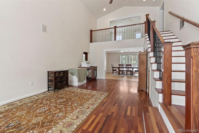 27987 Pine Grove Trl, Conifer, CO 80433 - foyer with wood finished floors, stairs, high vaulted ceiling, baseboards, and ceiling fan