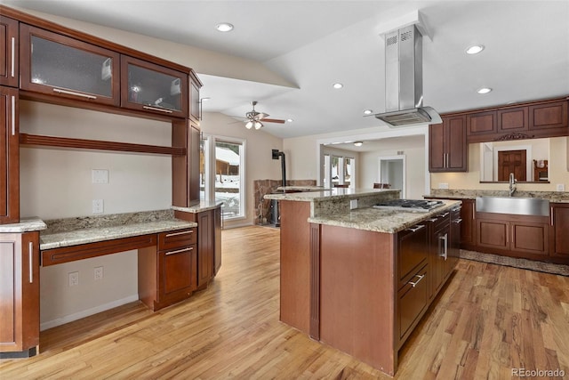 27987 Pine Grove Trl, Conifer, CO 80433 - kitchen featuring a sink, island range hood, stainless steel gas cooktop, light wood-style floors, and a ceiling fan