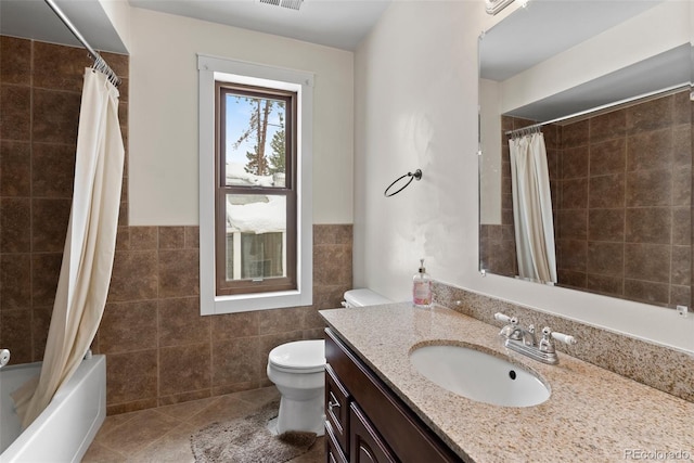 27987 Pine Grove Trl, Conifer, CO 80433 - full bath featuring tile walls, toilet, vanity, shower / bath combo with shower curtain, and tile patterned flooring