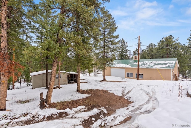 27987 Pine Grove Trl, Conifer, CO 80433 - view of front facade featuring an outdoor structure, an outbuilding, and metal roof