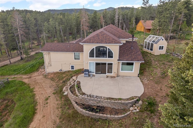 27987 Pine Grove Trl, Conifer, CO 80433 - rear view of property featuring a patio and a wooded view
