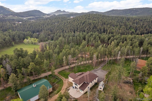 27987 Pine Grove Trl, Conifer, CO 80433 - drone / aerial view of a forest and a mountain backdrop