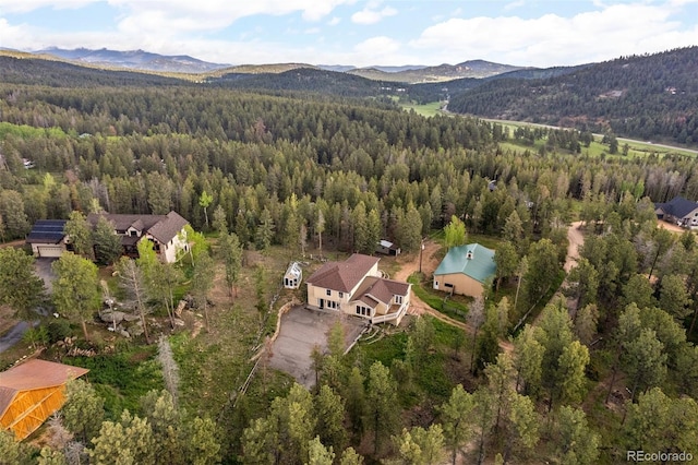 27987 Pine Grove Trl, Conifer, CO 80433 - aerial view of property and surrounding area featuring a heavily wooded area and a mountain backdrop