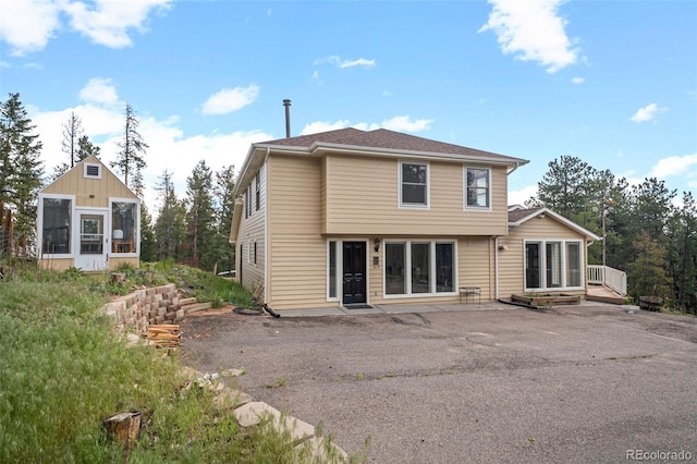 27987 Pine Grove Trl, Conifer, CO 80433 - back of house featuring a deck and a patio area