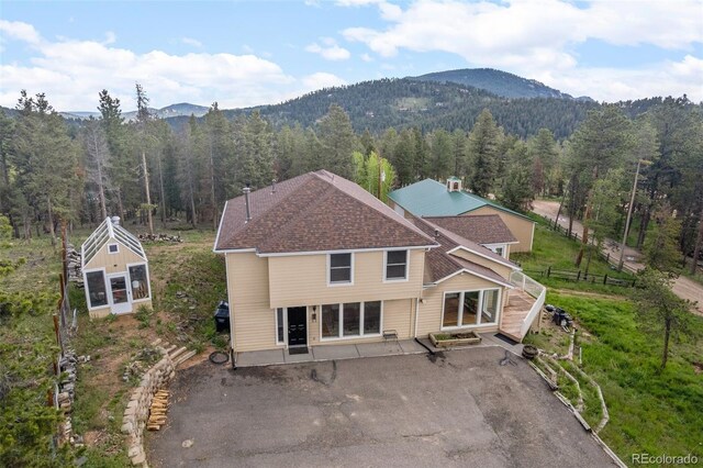 27987 Pine Grove Trl, Conifer, CO 80433 - rear view of property featuring a wooded view, a mountain view, stairway, and a patio area