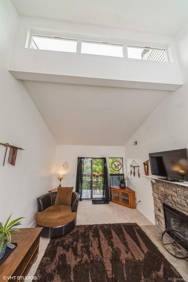 8654 Decatur St Unit 251, Westminster, CO 80031 - living room featuring carpet floors, lofted ceiling, healthy amount of natural light, and a fireplace