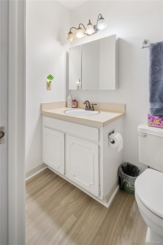 12522 W Virginia Ave, Lakewood, CO 80228 - bathroom featuring wood finished floors and vanity