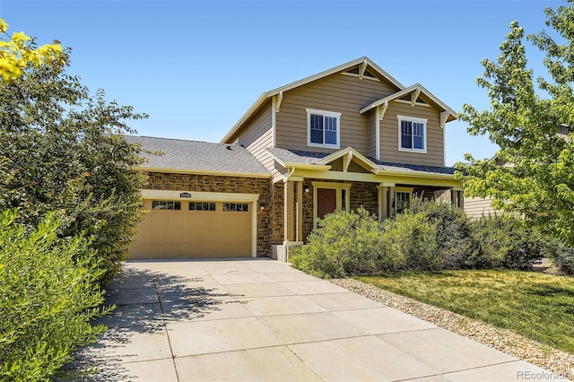 25792 E Cedar Pl, Aurora, CO 80018 - view of front of home with a garage, concrete driveway, stone siding, and a shingled roof