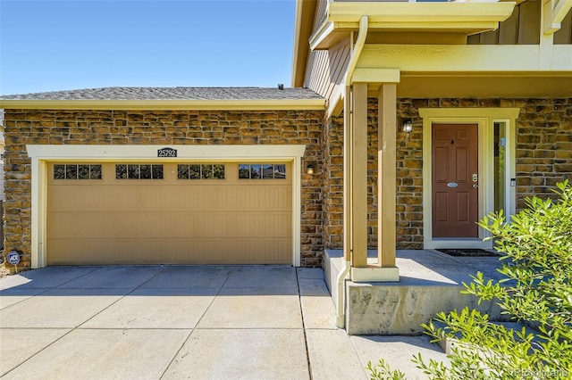 25792 E Cedar Pl, Aurora, CO 80018 - doorway to property featuring stone siding, driveway, roof with shingles, and an attached garage
