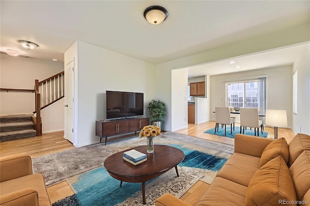 25792 E Cedar Pl, Aurora, CO 80018 - living area with light wood-style flooring and stairway