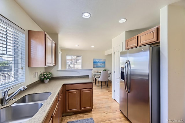 25792 E Cedar Pl, Aurora, CO 80018 - kitchen featuring stainless steel fridge, a peninsula, light wood-style floors, recessed lighting, and light countertops