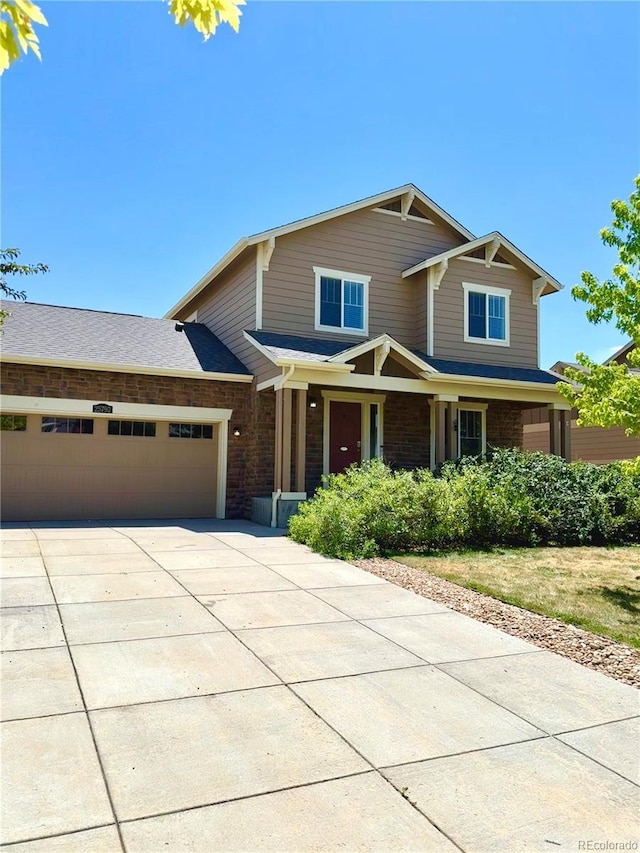 25792 E Cedar Pl, Aurora, CO 80018 - craftsman-style house with an attached garage, driveway, and brick siding