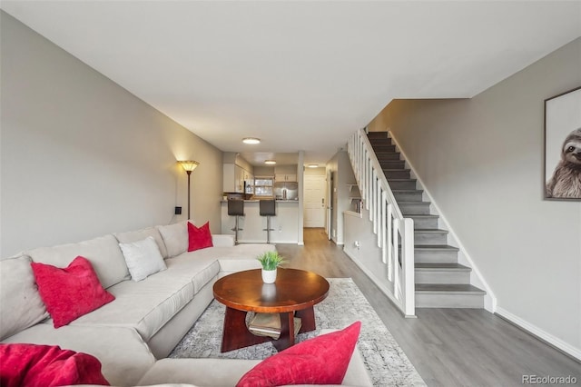 1818 S Quebec Way Unit 11-3, Denver, CO 80231 - living area featuring wood finished floors, stairway, and baseboards