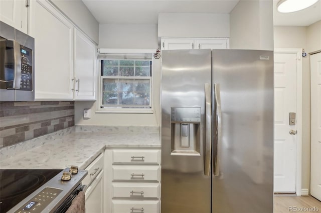1818 S Quebec Way Unit 11-3, Denver, CO 80231 - kitchen with stainless steel appliances, white cabinets, tasteful backsplash, and light stone counters