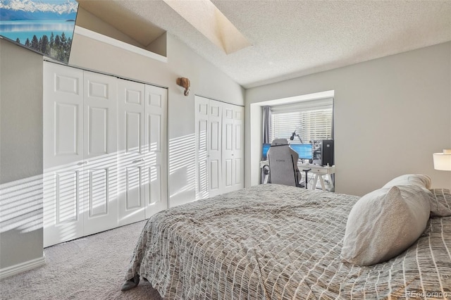 1818 S Quebec Way Unit 11-3, Denver, CO 80231 - bedroom featuring carpet flooring, two closets, vaulted ceiling, and a textured ceiling