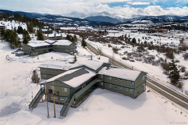 snowy aerial view featuring a mountain view