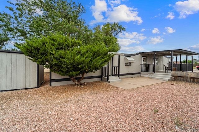 rear view of property with a storage shed