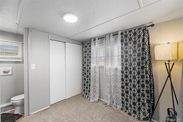 carpeted bedroom featuring a closet and connected bathroom