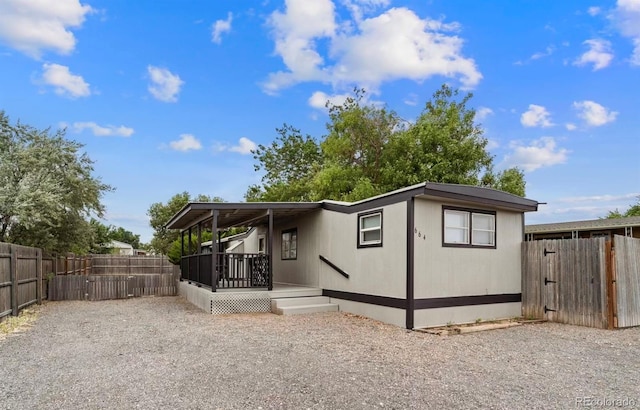 rear view of property featuring a deck