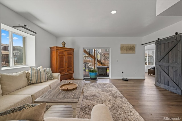1114 Basalt Ridge Loop, Castle Rock, CO 80108 - living area featuring a barn door, healthy amount of natural light, wood finished floors, recessed lighting, and baseboards