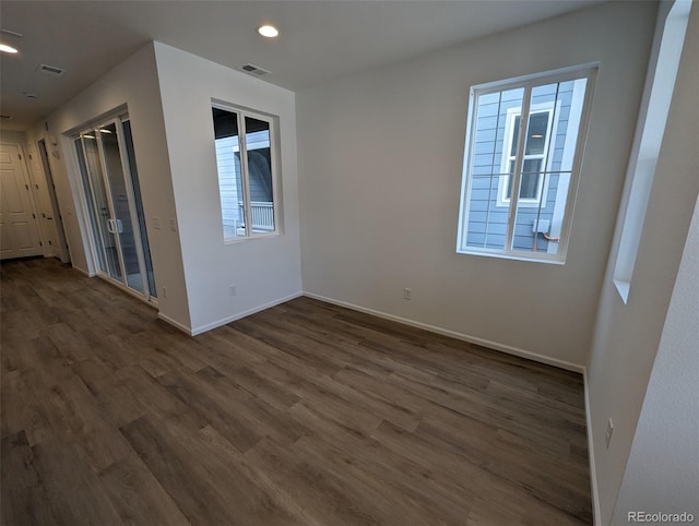 unfurnished room featuring dark hardwood / wood-style flooring