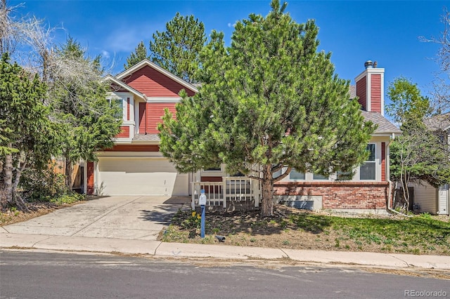 17509 E Kenyon Dr, Aurora, CO 80013 - obstructed view of property featuring a garage, driveway, brick siding, and a chimney