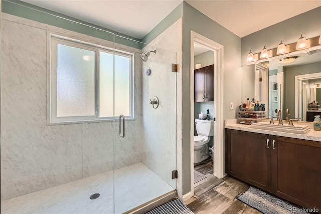 17509 E Kenyon Dr, Aurora, CO 80013 - full bathroom featuring a stall shower, vanity, and wood finished floors