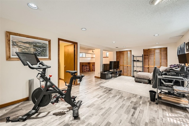 17509 E Kenyon Dr, Aurora, CO 80013 - exercise area with light wood-type flooring, recessed lighting, and a textured ceiling
