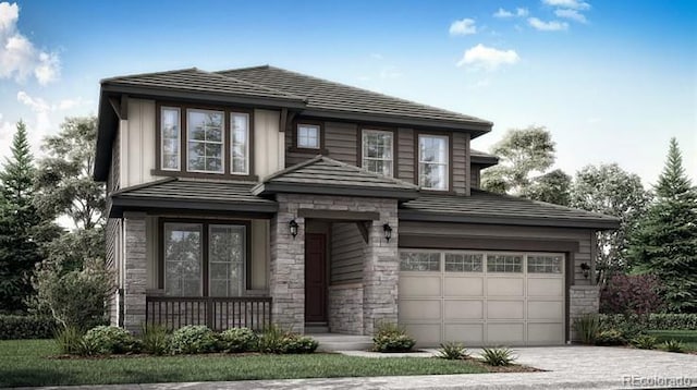 prairie-style house featuring a garage, stone siding, and driveway