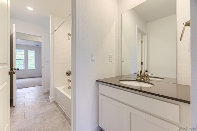 7440 S Yank Ct, Littleton, CO 80127 - bathroom with vanity, tub / shower combination, tile patterned floors, and a textured wall